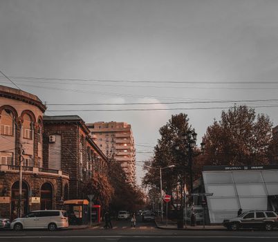 City street view showcasing urban architecture and pedestrians at dusk.