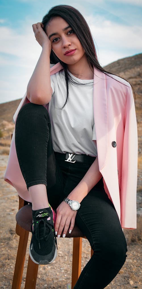 A Woman Sitting on a Stool for an Outdoor Photoshoot