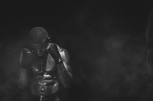 A striking black and white portrait of a muscular fighter in Kinshasa.