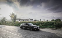 A Black Sedan on the Road