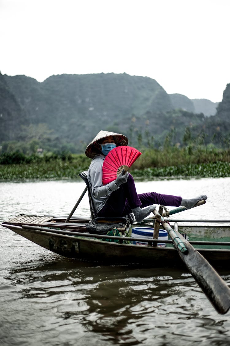 A Person Riding A Wooden Boat