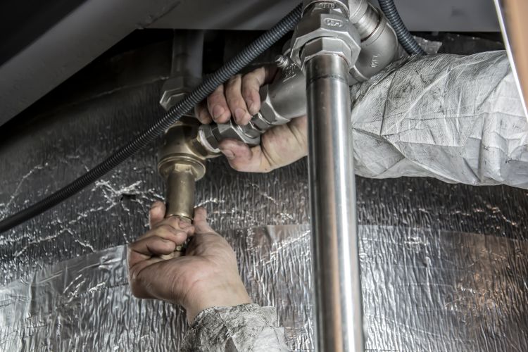 Professional plumber repairing residential pipes