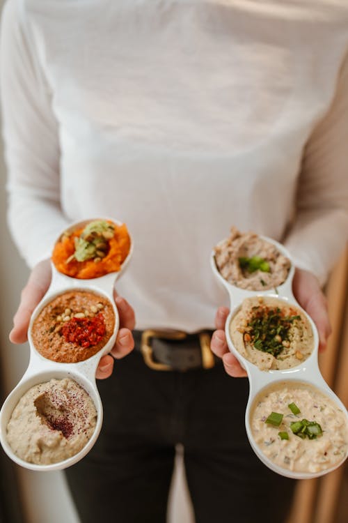 Free Person Holding Various Hummus Stock Photo