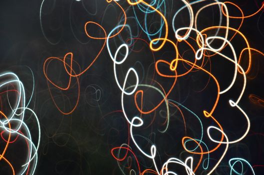 Vibrant abstract image featuring dynamic, colorful light trails against a dark background.