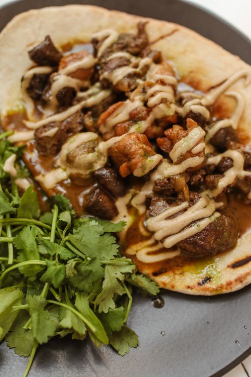 Curry chicken served over torn roti