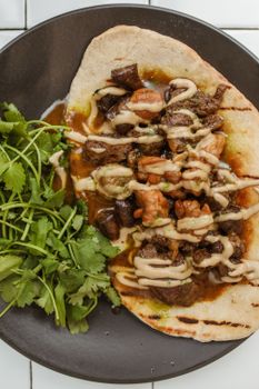 Delicious grilled pita topped with savory mushrooms, herbs, and dressing.