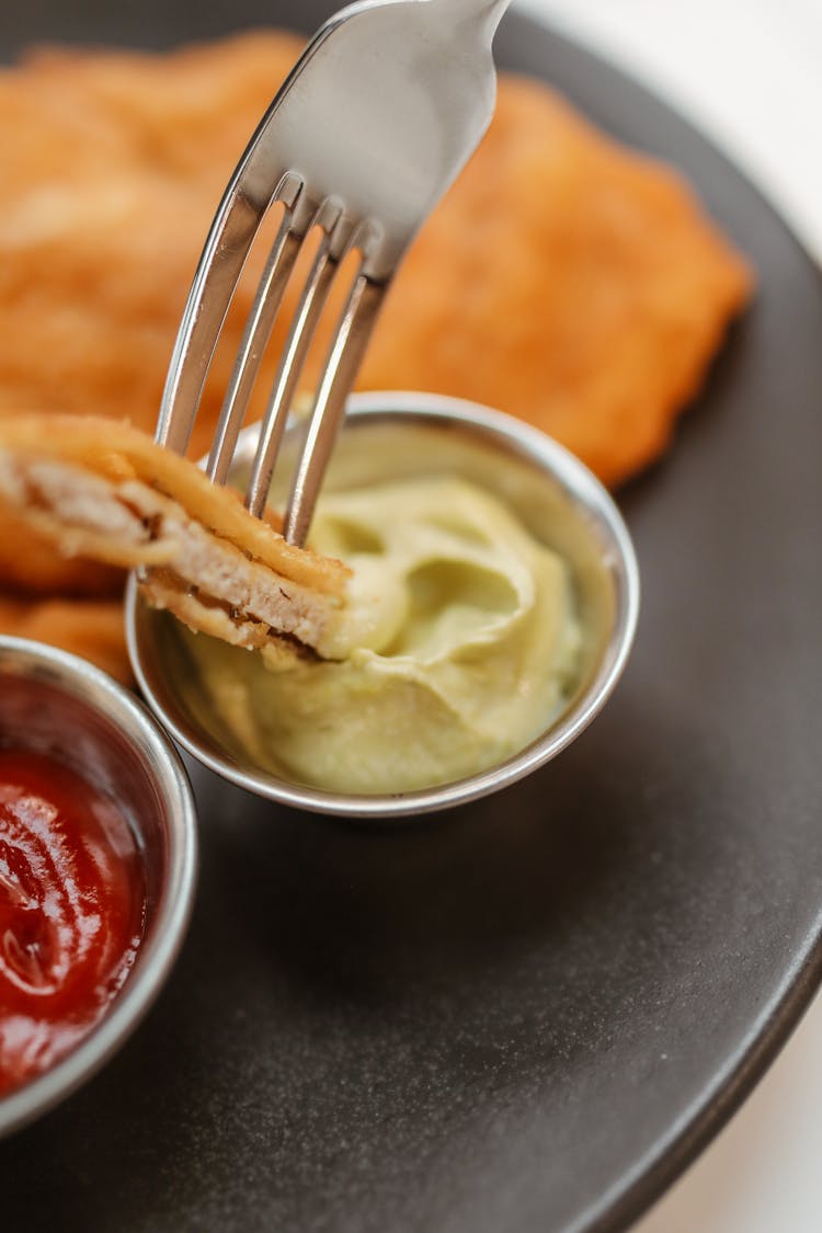 Dipping Of Meat Cutlet On A Sauce