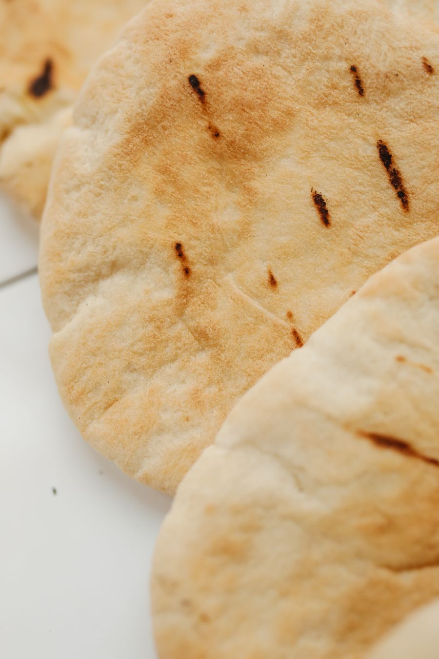 Close detail of a freshly baked pita's crust
