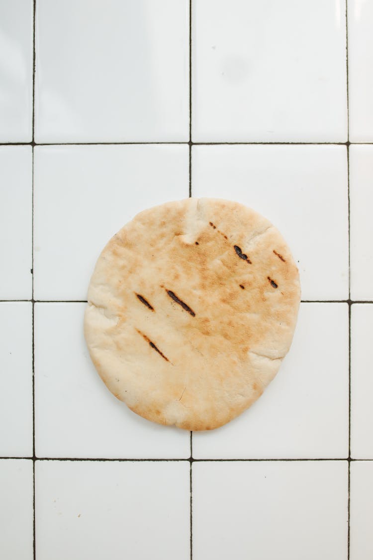 A Pita Bread Over A Ceramic Tile