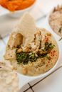 Dipping Pita Bread in Jewish Hummus Paste