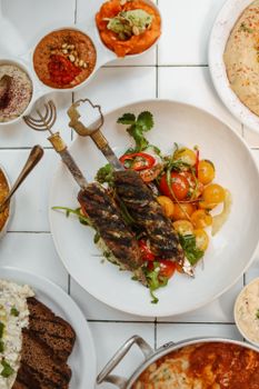 Delicious spread featuring grilled kebabs, hummus, and vibrant side dishes showcasing Middle Eastern flavors.