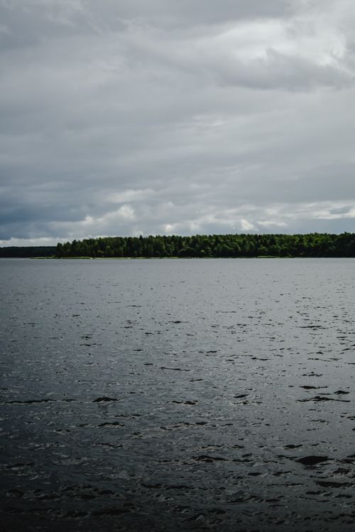 Free A peaceful lake in Estonia with a cloudy sky, capturing natural beauty and calm waters. Stock Photo