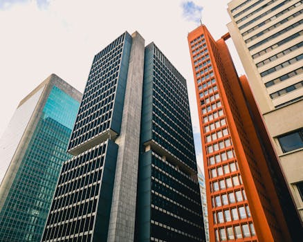 Low angle view of modern skyscrapers against a clear sky.