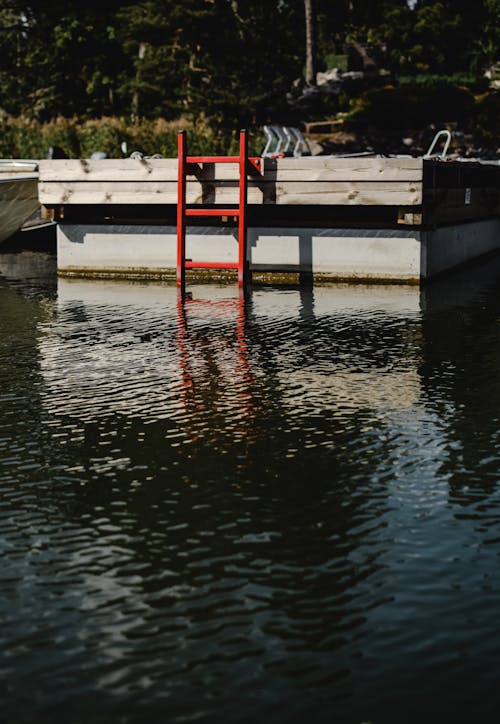 Muelle De Madera Rojo Y Blanco En Cuerpo De Agua