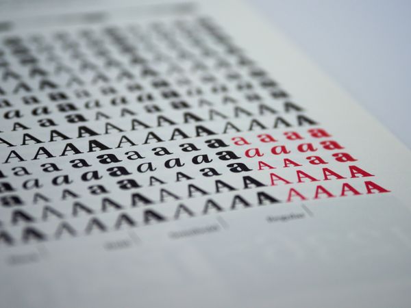 Printed type specimen sheet showing rows of the letter A in black and red — photo by Brett Jordan on Pexels
