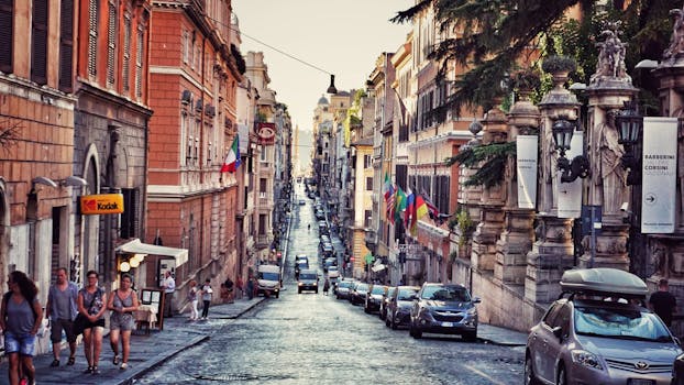 Busy urban street in Rome with people, cars, and historic architecture showcasing Italian urban lifestyle.
