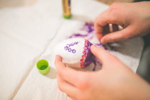 Close up of girl hands coloring easter eggs