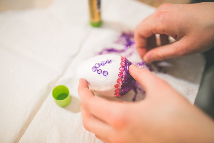 Close Up Of Girl Hands Coloring Easter Eggs