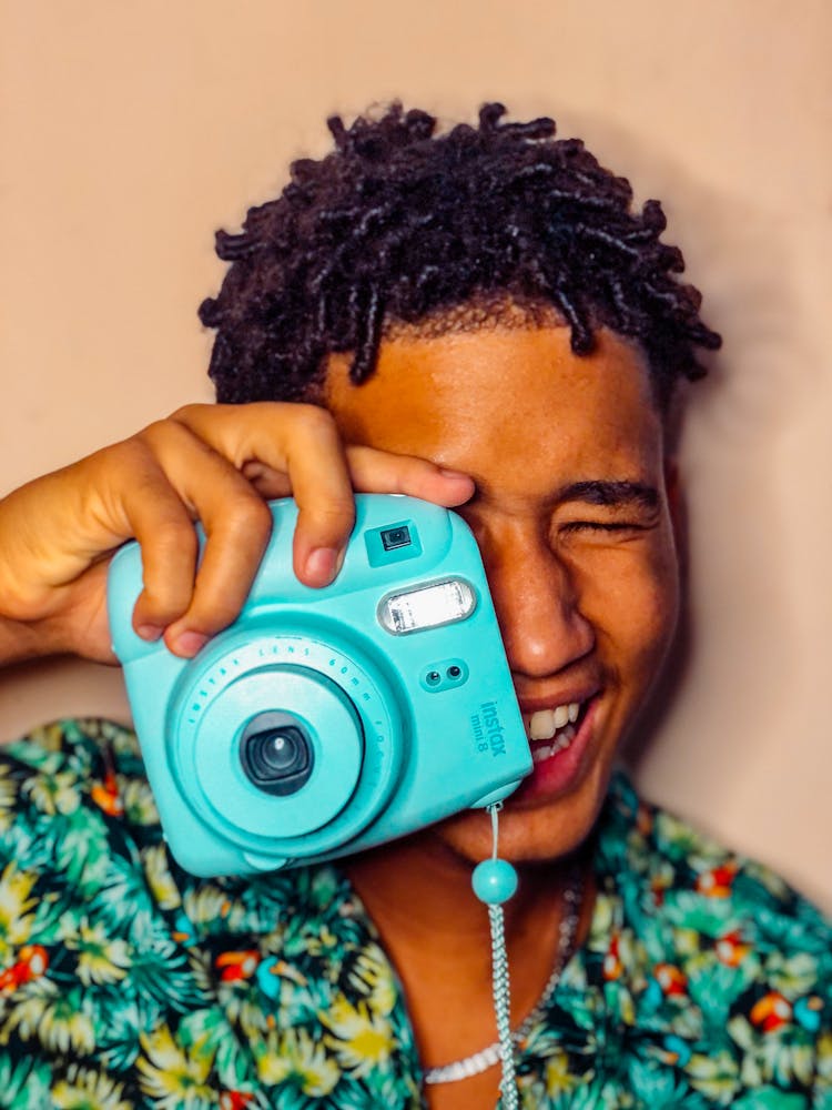 Man Holding An Instant Camera