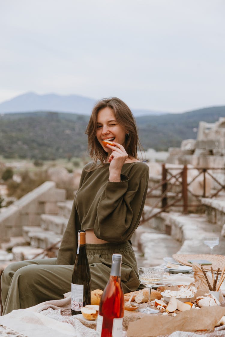 Woman Posing White Biting A Slice Of Apple 