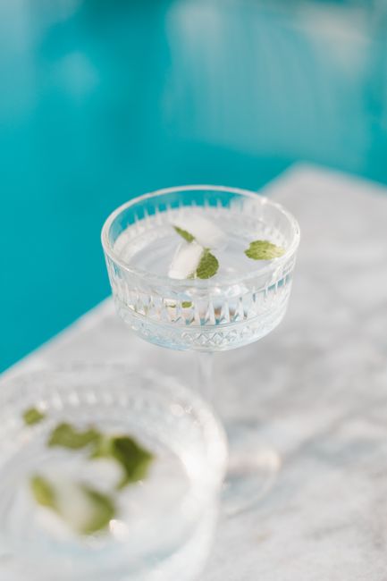 Refreshing mocktail with mint leaves in a crystal glass by the pool.