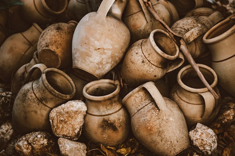 A Pile Of Dirty Clay Jars