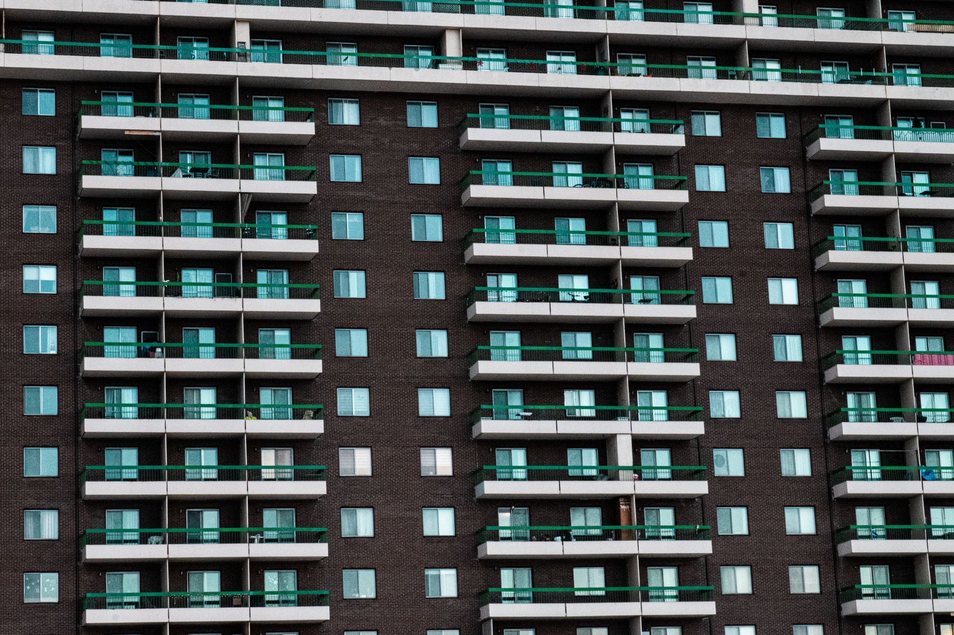 Close-up view of a modern apartment building facade with balconies in Montreal, Canada.