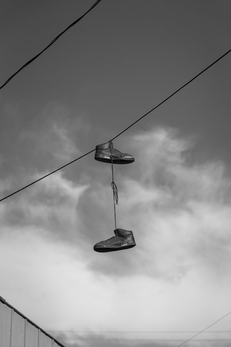 A Pair Of Shoes Hanging On Wires