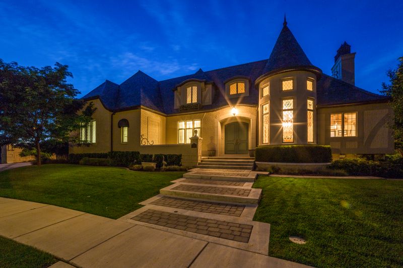 Home exterior at dusk with lit windows, photo by Get Lost Mike on Pexels