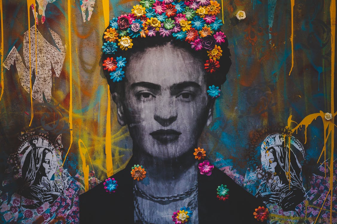 Free Creative artwork with Frida Kahlo painting decorated with colorful floral headband on graffiti wall Stock Photo