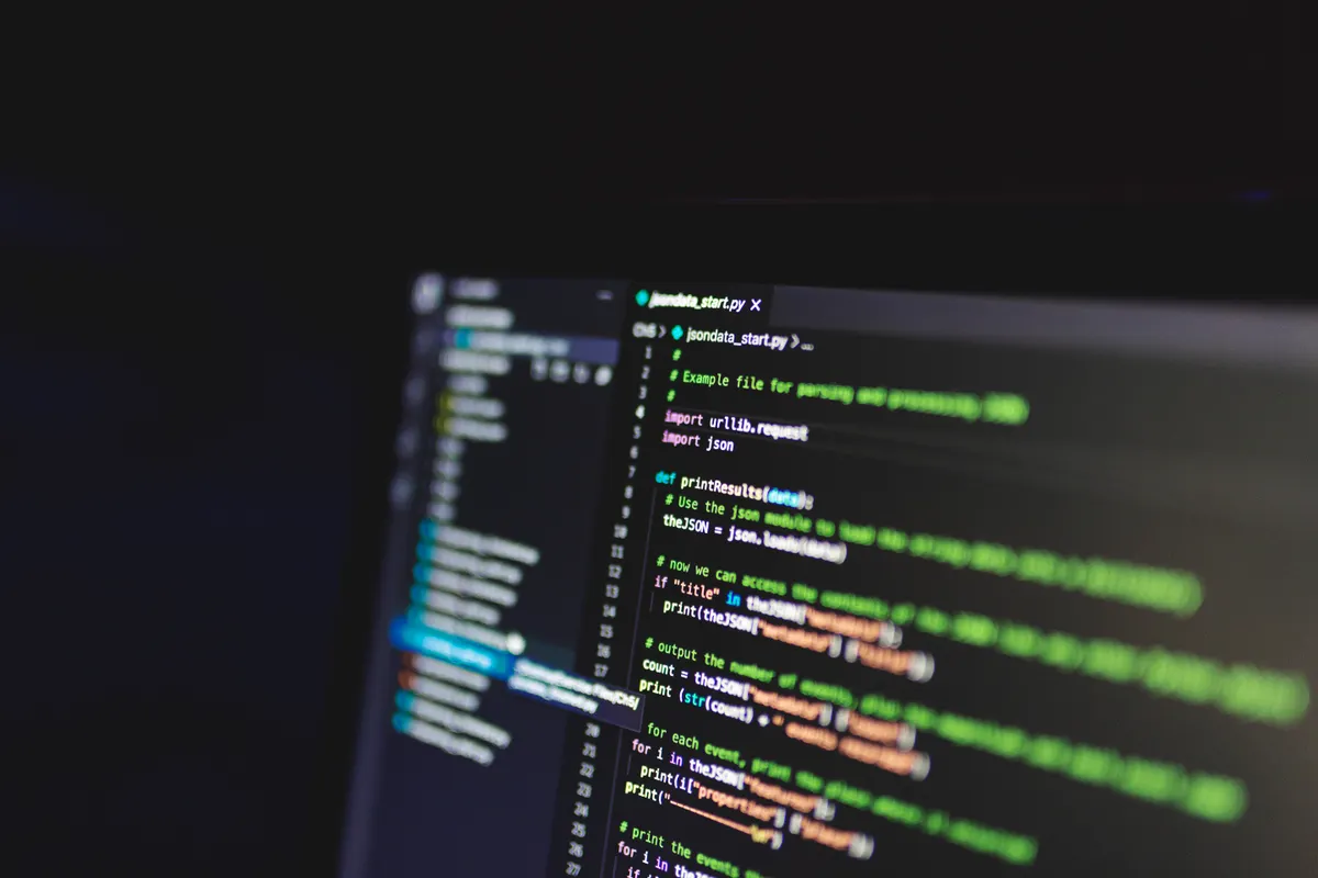 Programming code displayed on a dark computer screen, representing a Pine Script strategy being edited in the Pine Editor