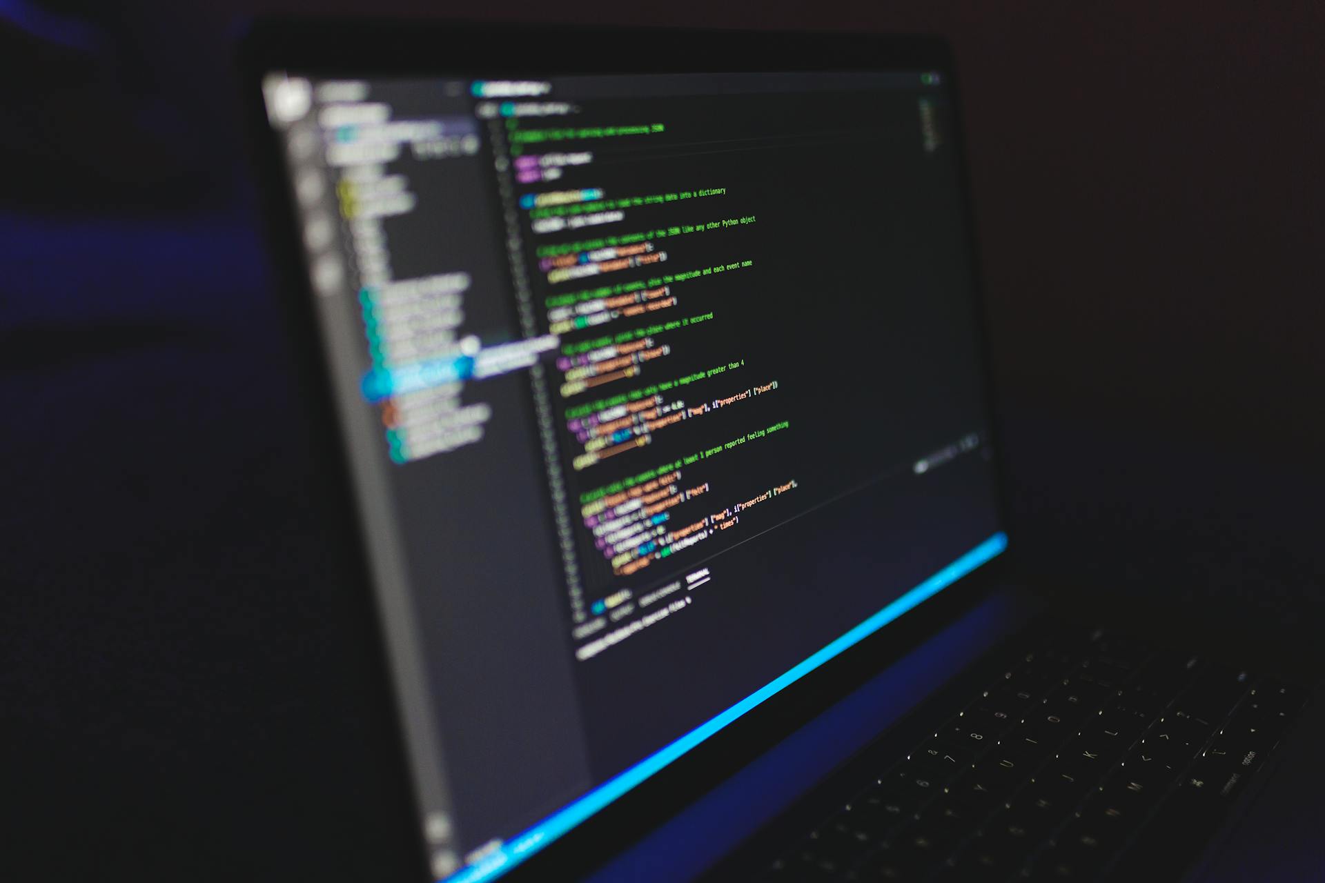 Laptop displaying code in a dark setting, highlighting programming concepts and digital work.