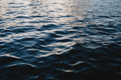 Free From above of rippling blue water of ocean illuminated by light in daytime Stock Photo