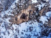 Cross located in mountain cave on snowy winter