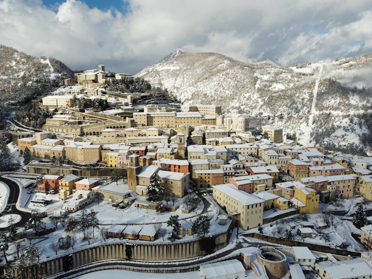 Small Town Covered With Snow In Hilly Terrain