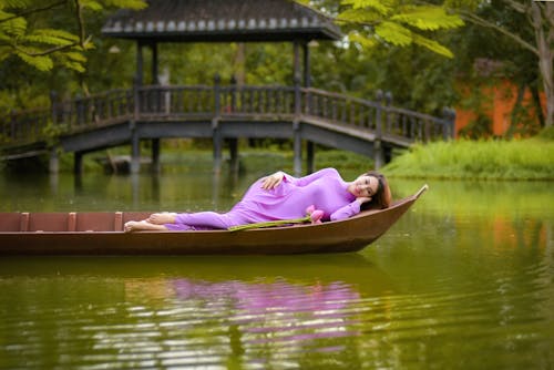 Free A Beautiful Woman Lying on a Boat Stock Photo