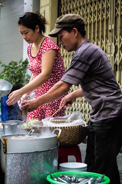 A Couple Cooking Street Food