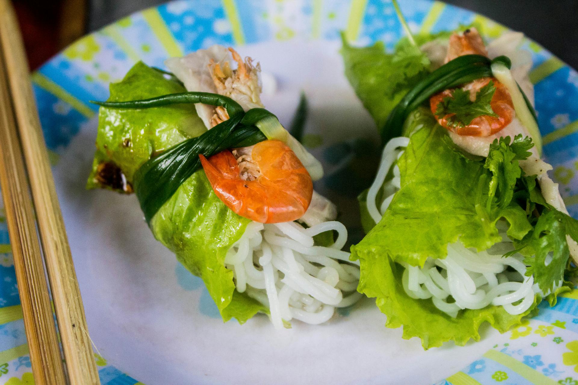 Close-up of fresh shrimp and rice noodle lettuce wraps on a colorful plate, perfect for healthy eating.