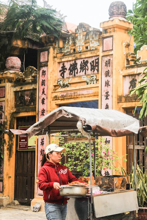 Woman with a Cap Setting Up Her Food Stall