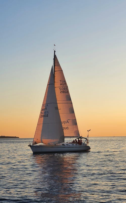 People on a Sailboat with a Scenic Twilight
