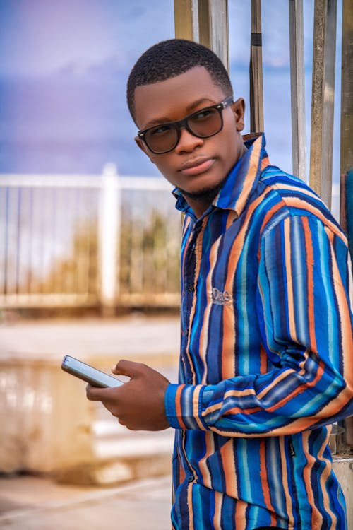 A Stylish Man Holding a Cellphone