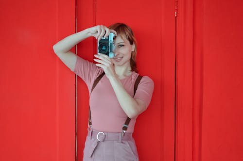 Portrait of Woman Taking Pictures with Retro Camera