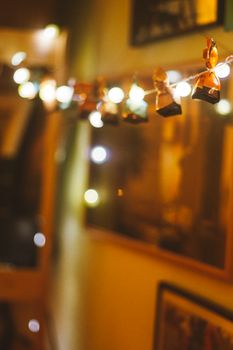 Cozy indoor setting with soft focus festive string lights and decor, creating a warm ambiance.