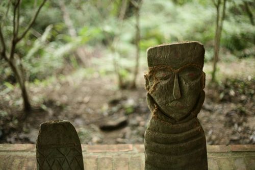 Free Explore the mystique of carved wooden sculptures set amidst a serene forest backdrop. Stock Photo