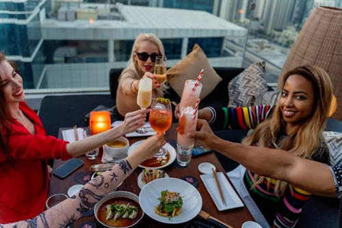 Free Friends Clinking their Glasses at the Table Stock Photo