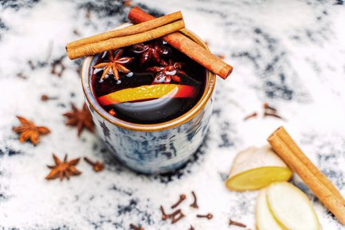 Free Delightful spiced drink with cinnamon sticks, star anise, and citrus slices. Perfect for cozy seasons. Stock Photo