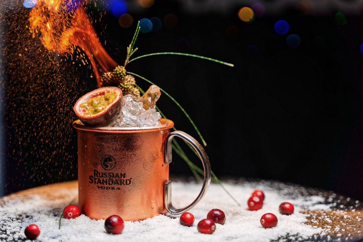 Drink served in a copper mug with a festive garnish