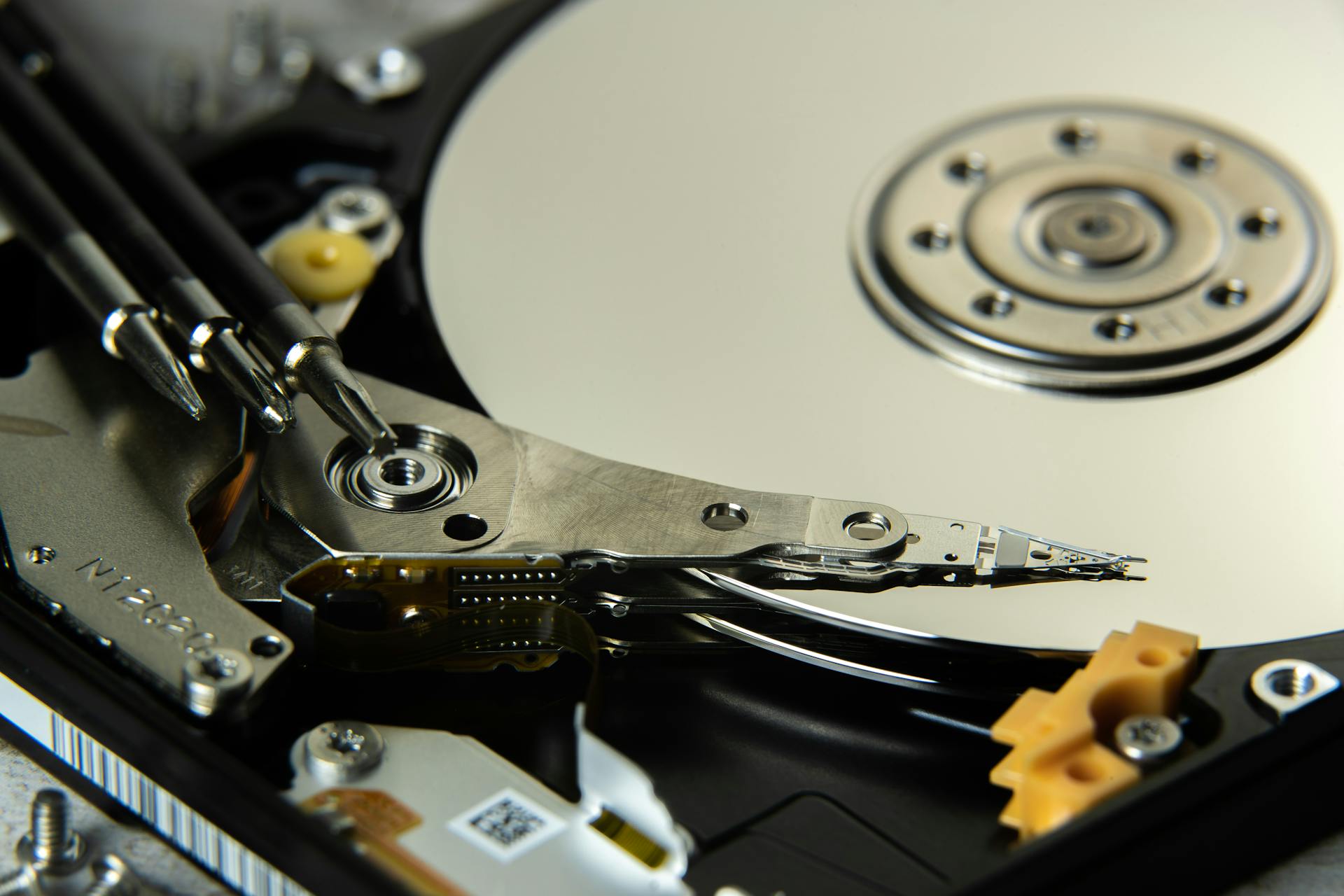 Detailed view of internal hard drive platters and read/write heads for data storage technology.