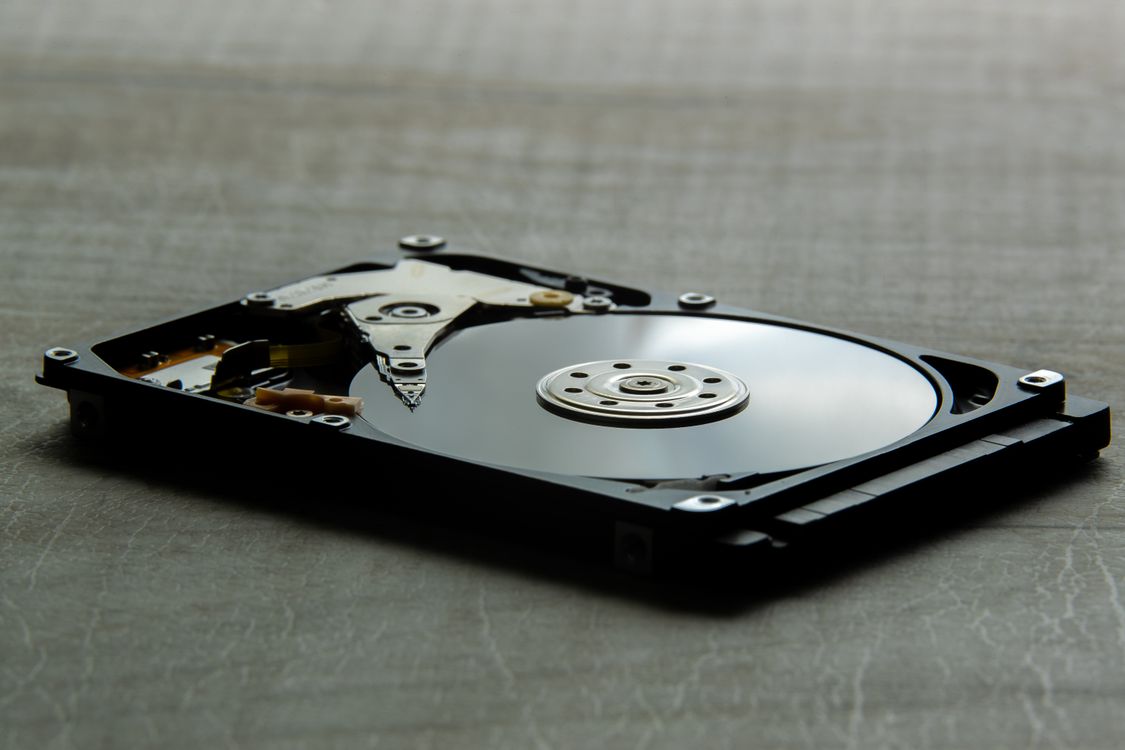 Computer Hard Drive Laid on Gray surface · Free Stock Photo