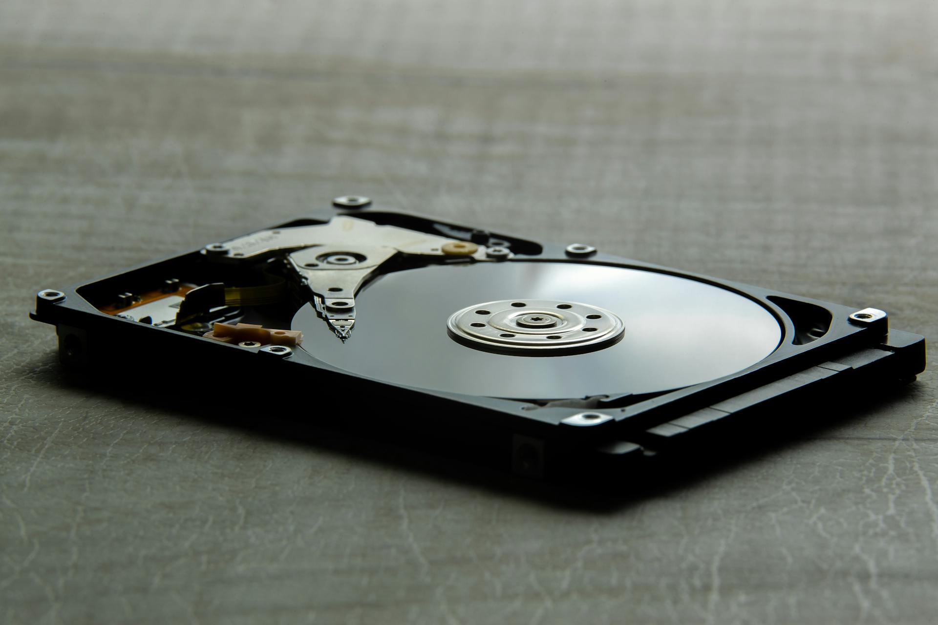 Detailed view of an open hard disk drive showing its internal components.